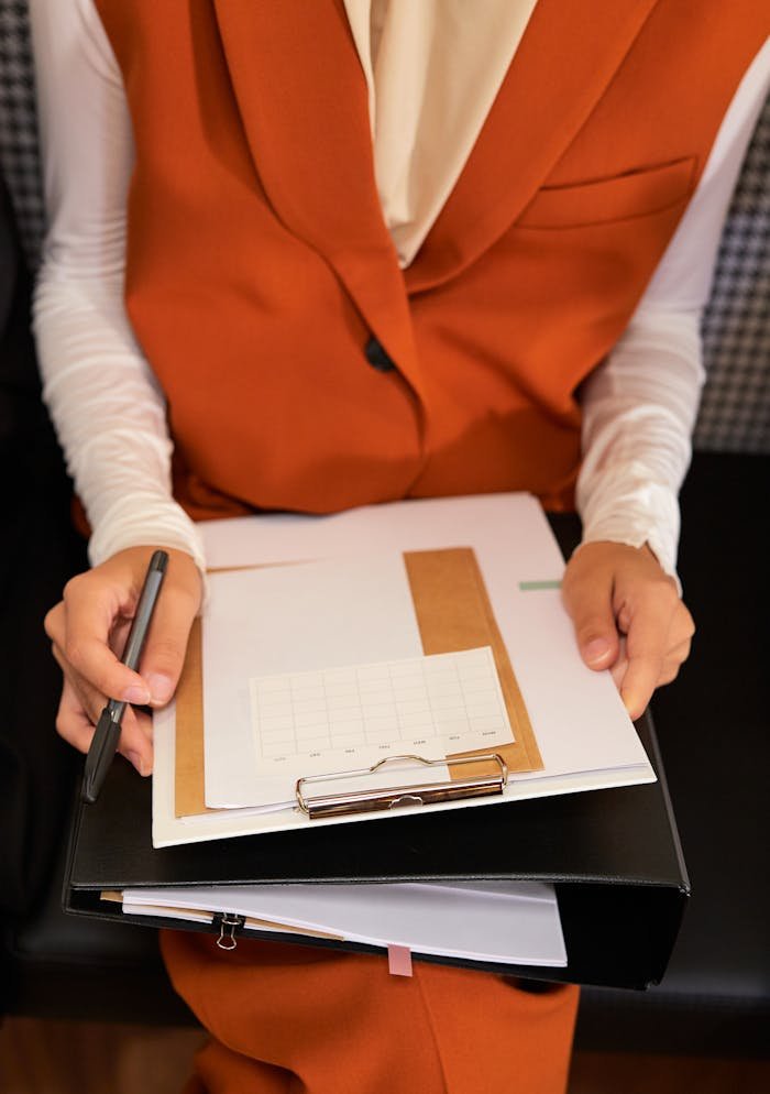The Art of Drawing Readers In: Your attractive post title goes here Businesswoman holding a clipboard with notes, planning and organizing tasks.