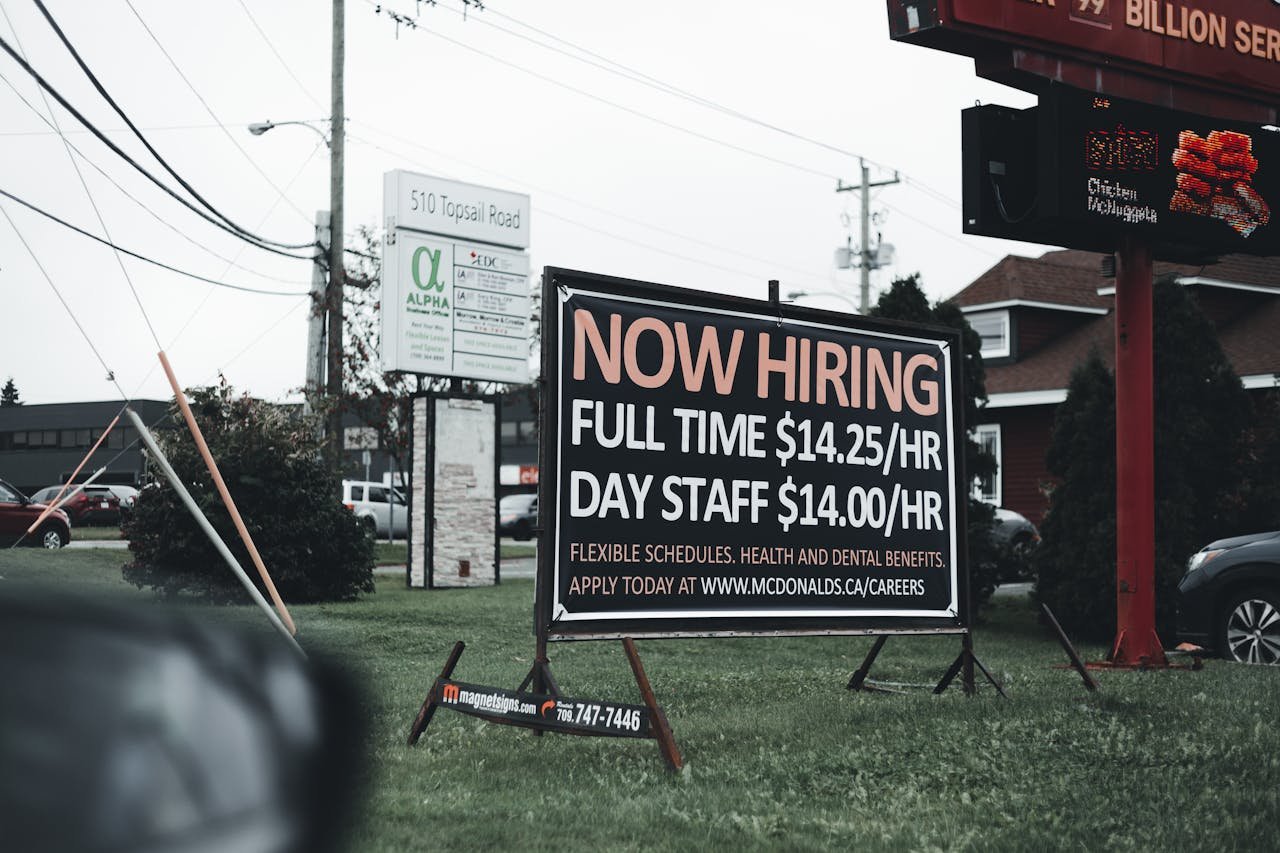The Art of Drawing Readers In: Your attractive post title goes here Outdoor hiring sign advertising restaurant job openings with competitive wages and benefits.